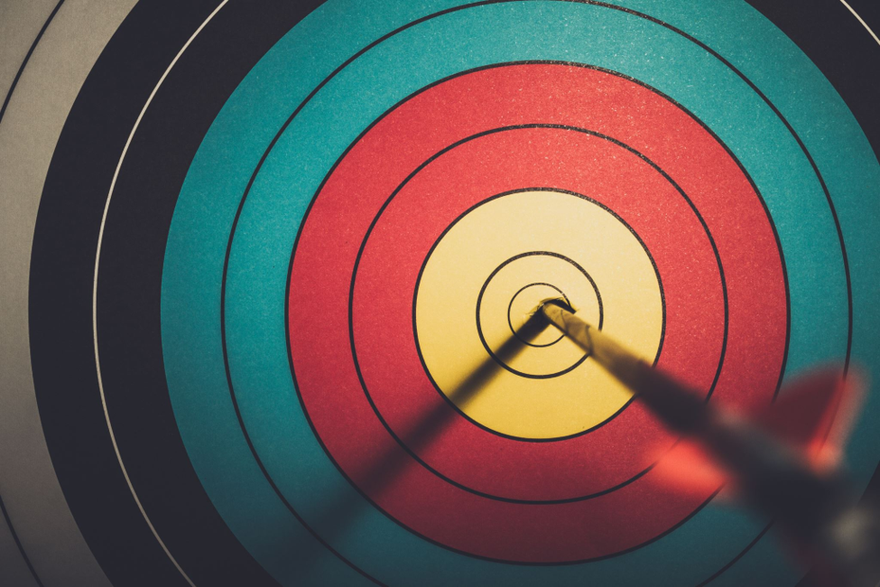 Arrow striking the bullseye of a target